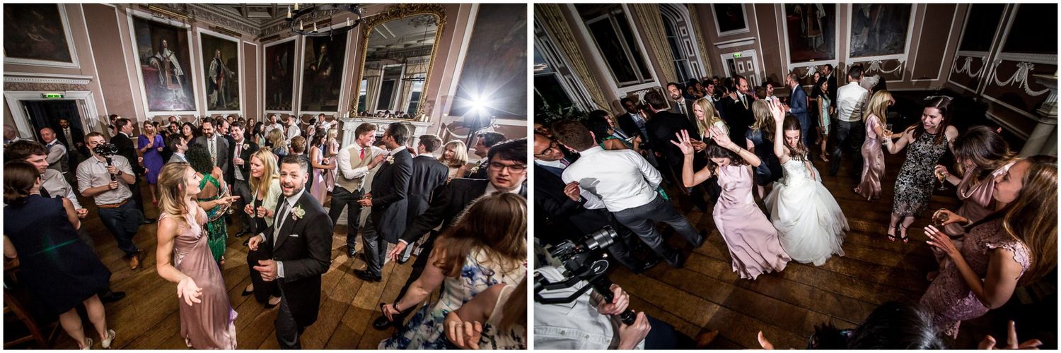 Wedding guests dance and celebrate together on a crowded dance floor during an energetic reception party.