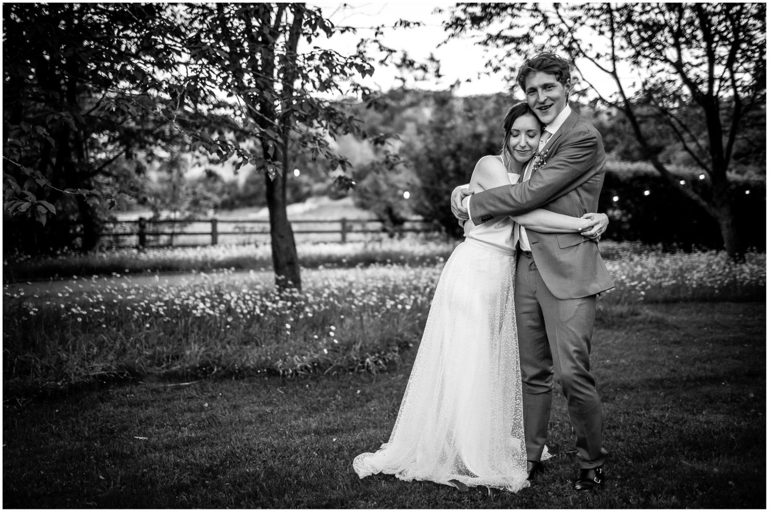 Black and white wedding portraits in a rustic outdoor setting.