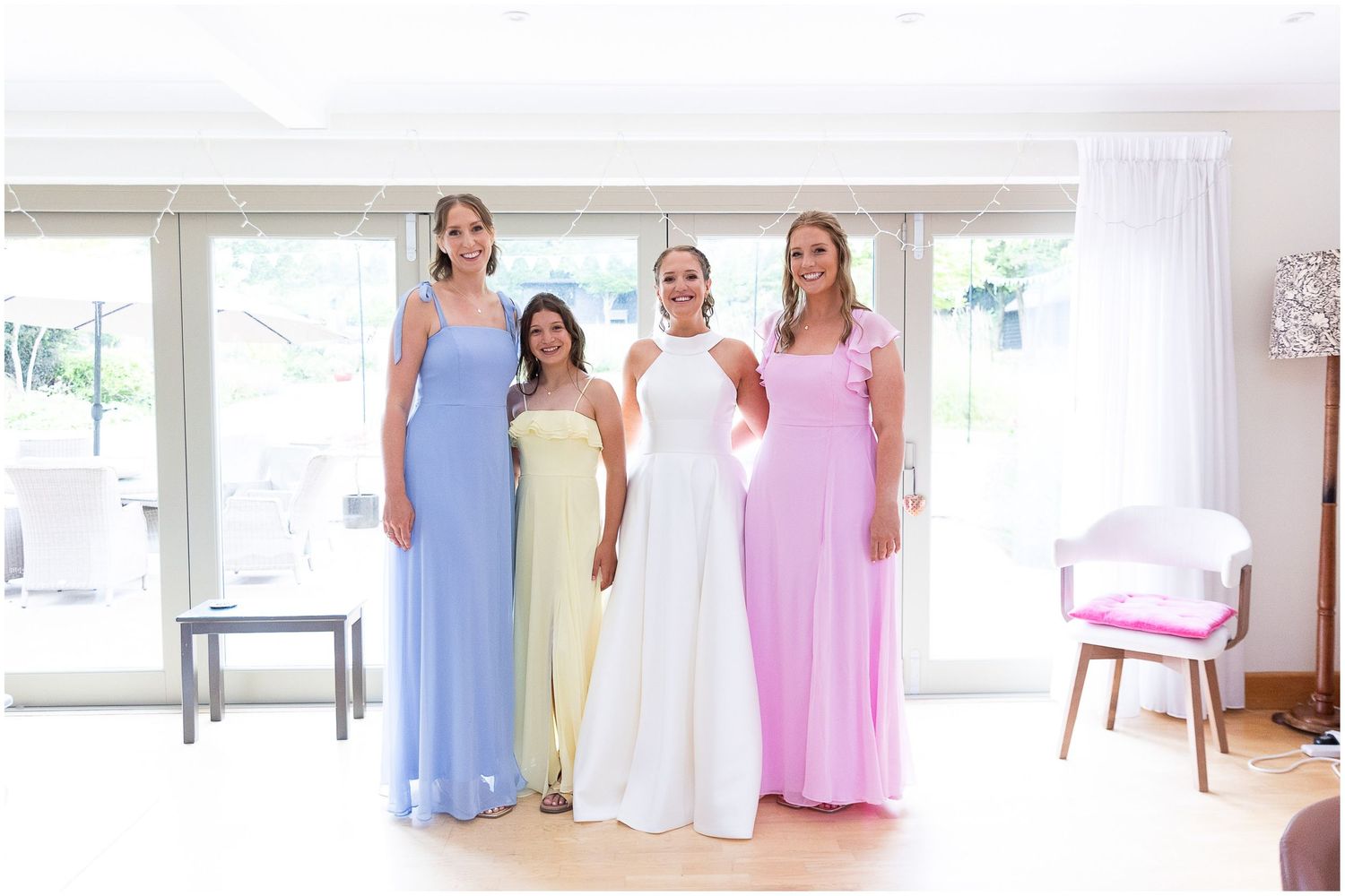 A group photograph of bride and bridesmaids at home before the wedding.