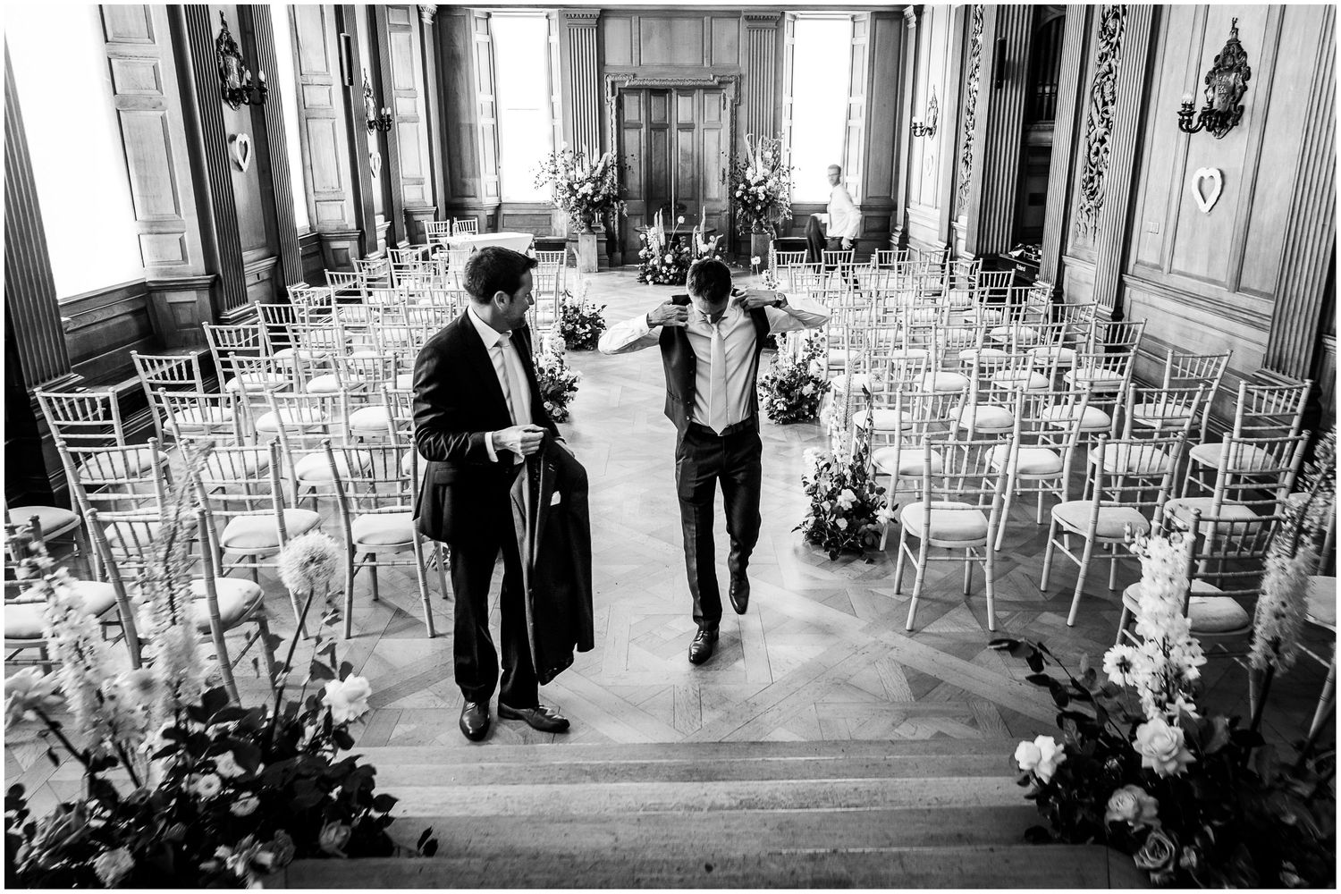 Black and white photograph of groom and groomsmen in the ceremony hall at Walhampton School in the New Forest before a wedding