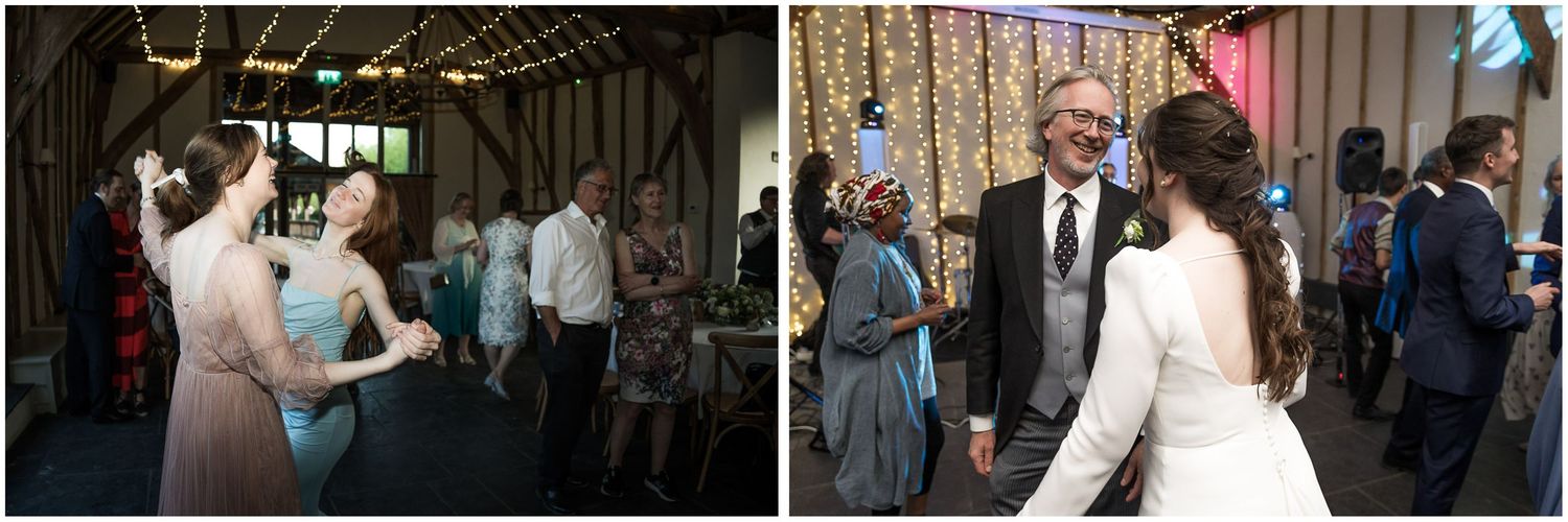 Wedding guests celebrate and dance together at an indoor reception venue.