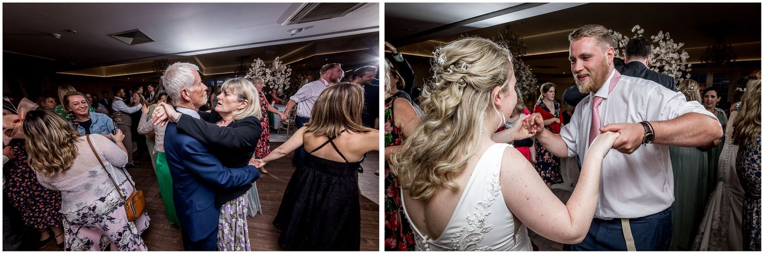Wedding reception guests dancing and celebrating on crowded dance floor.