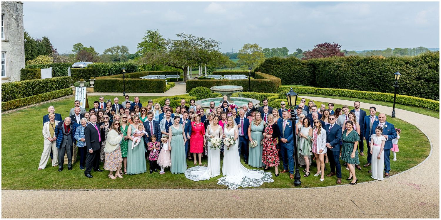 Panoramic group photos of wedding guests on manicured garden grounds.