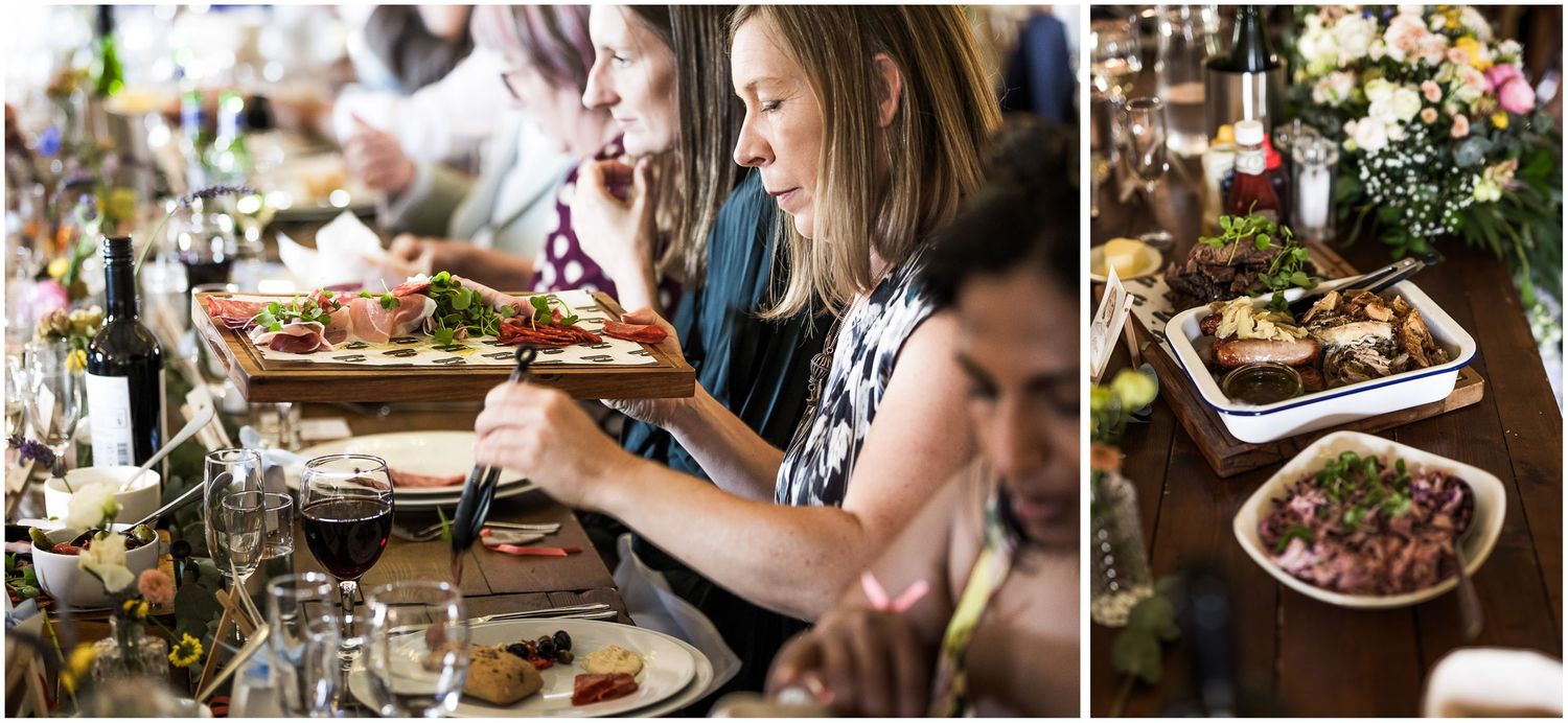 Wedding guests sharing trays and platters of food for the main course of the wedding breakfast at Sopley Mill