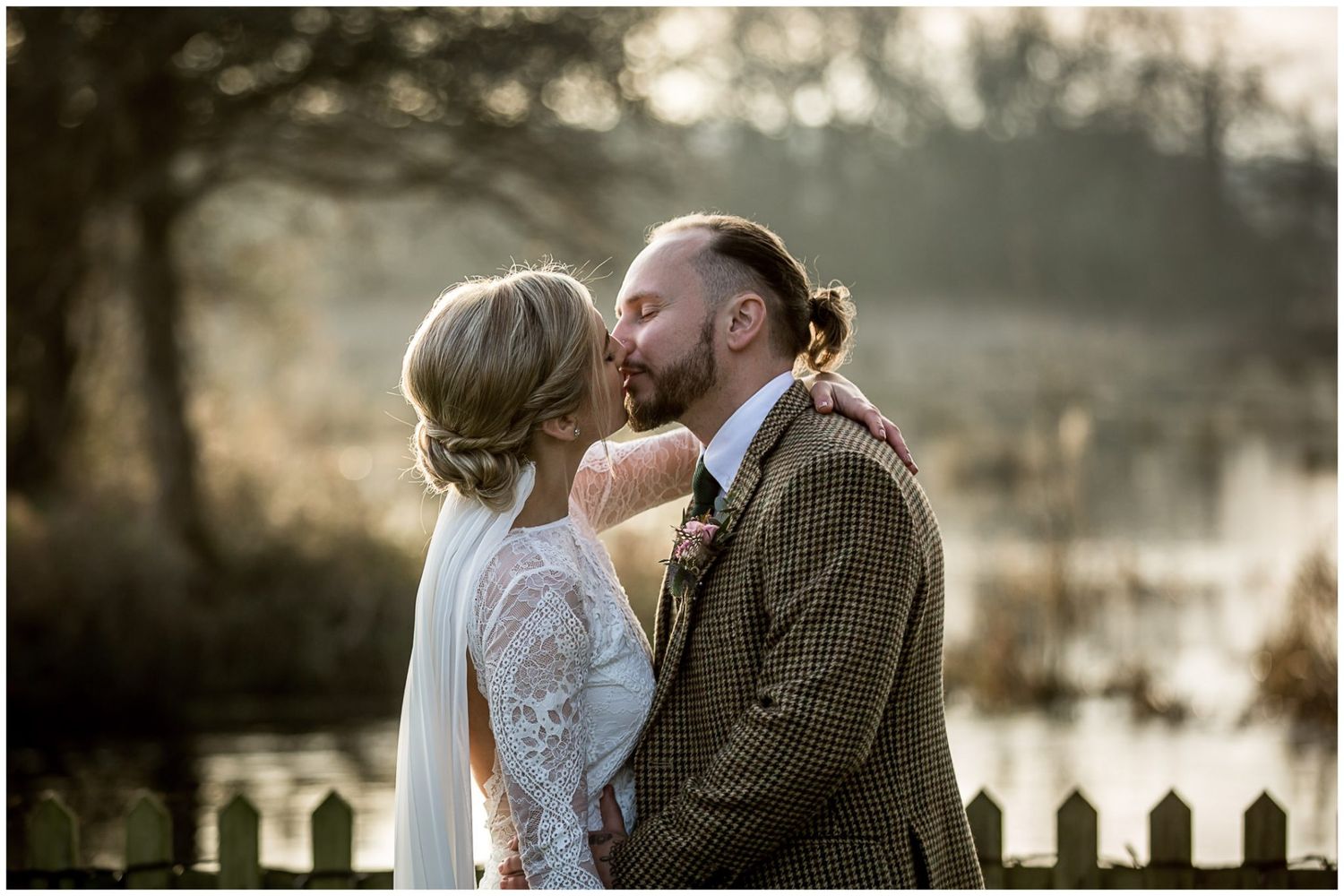 Intimate wedding moments captured against rustic winter landscape with wooden fence.