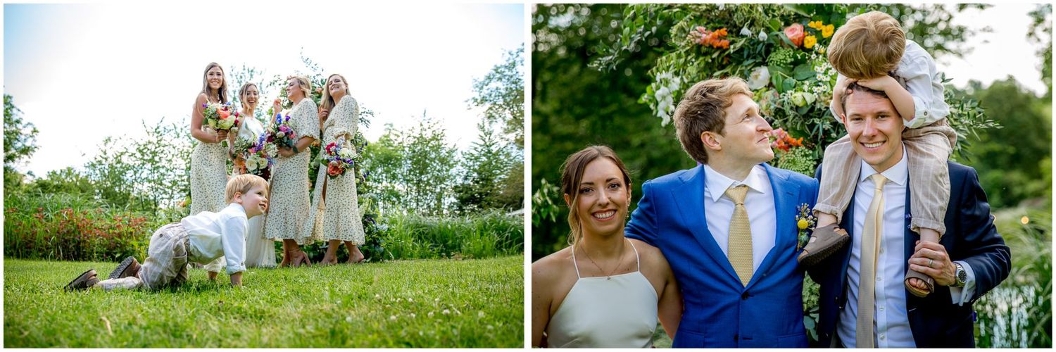Outdoor wedding celebration with guests mingling on a sunny lawn surrounded by greenery.