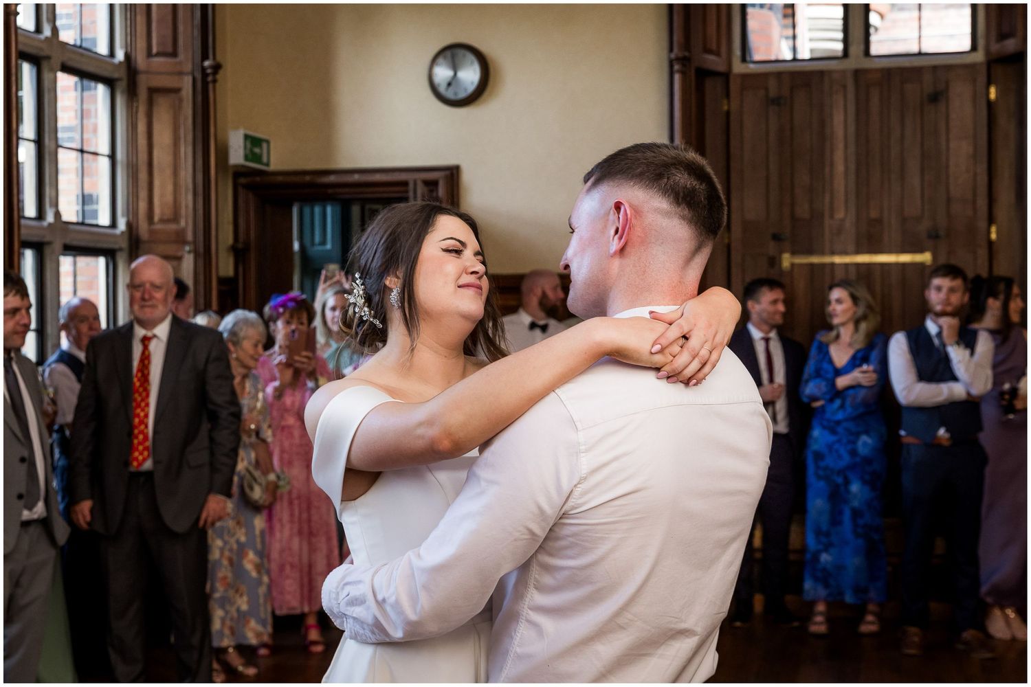 A couple shares their first dance as newlyweds in the evening reception hall at The Elvetham, Hampshire wedding hotel.