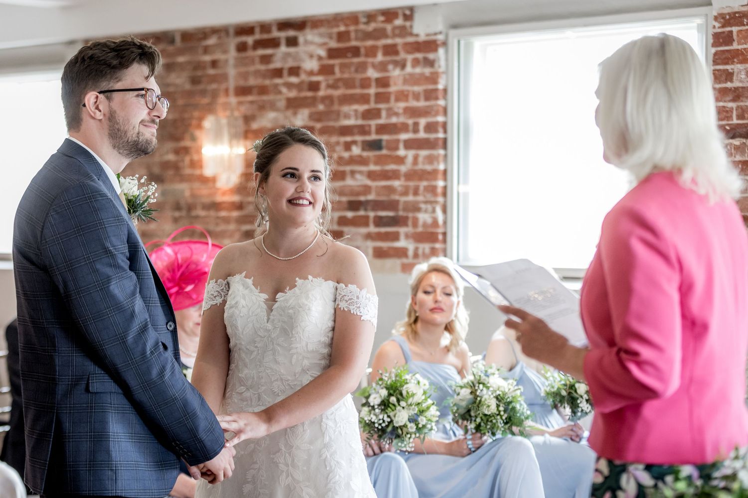 Wedding celebration in a rustic venue with exposed brick walls and elegant decor.