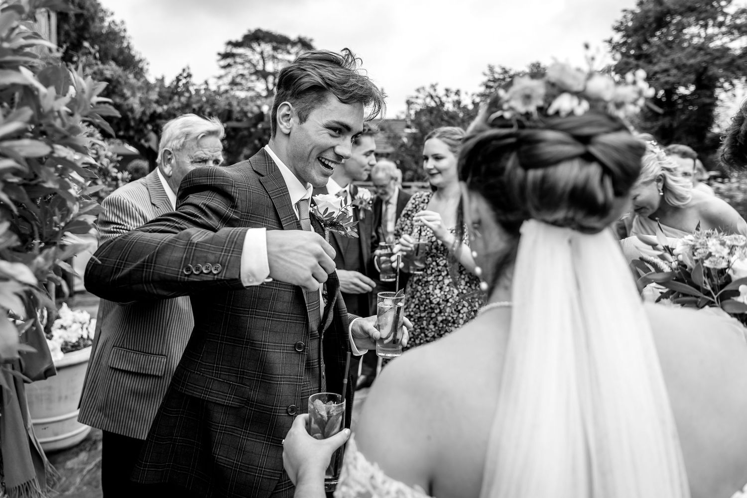 Black and white wedding photos capturing candid emotional moments between guests.