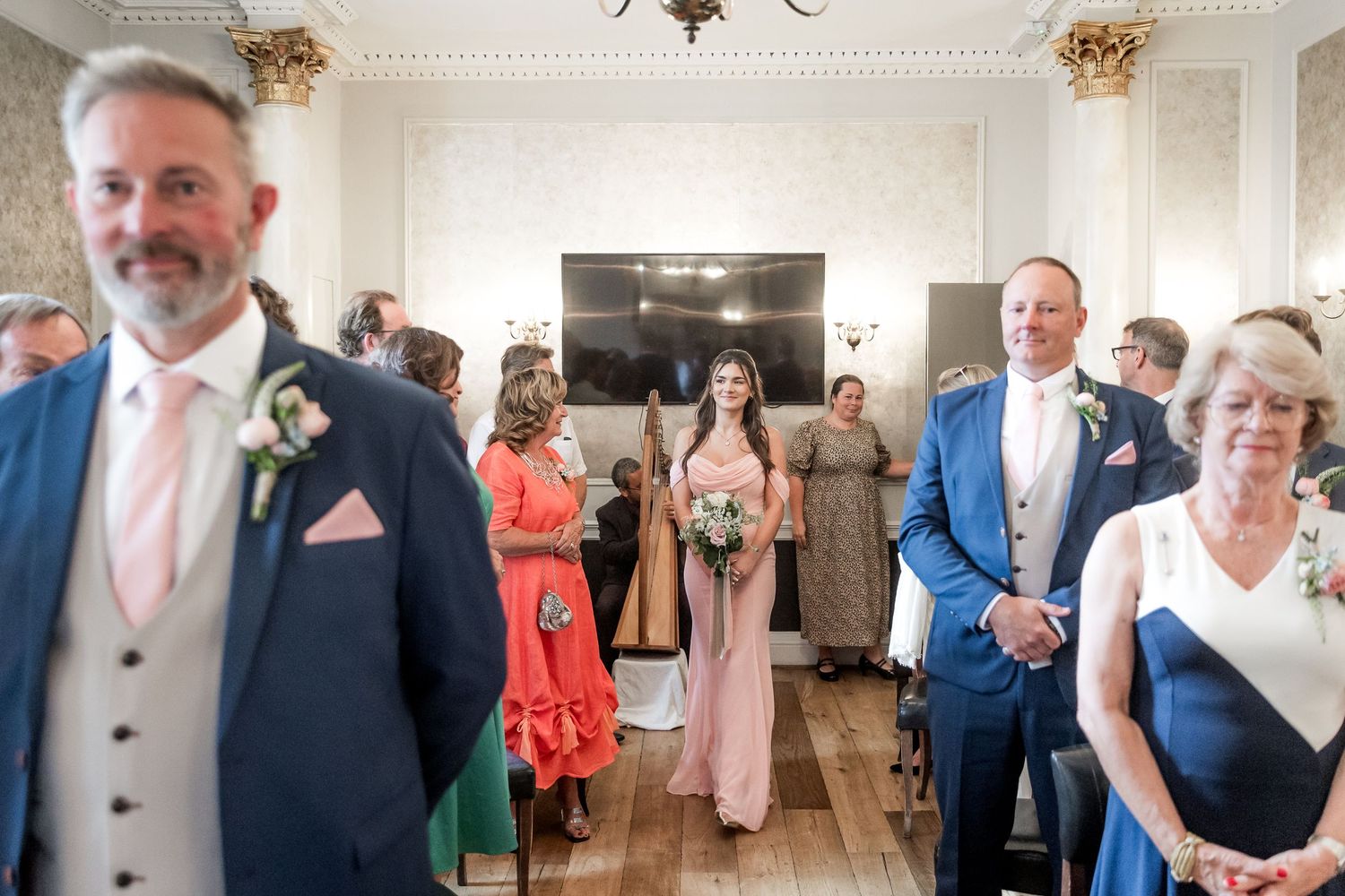 Wedding reception venue with elegant decor and guests mingling.