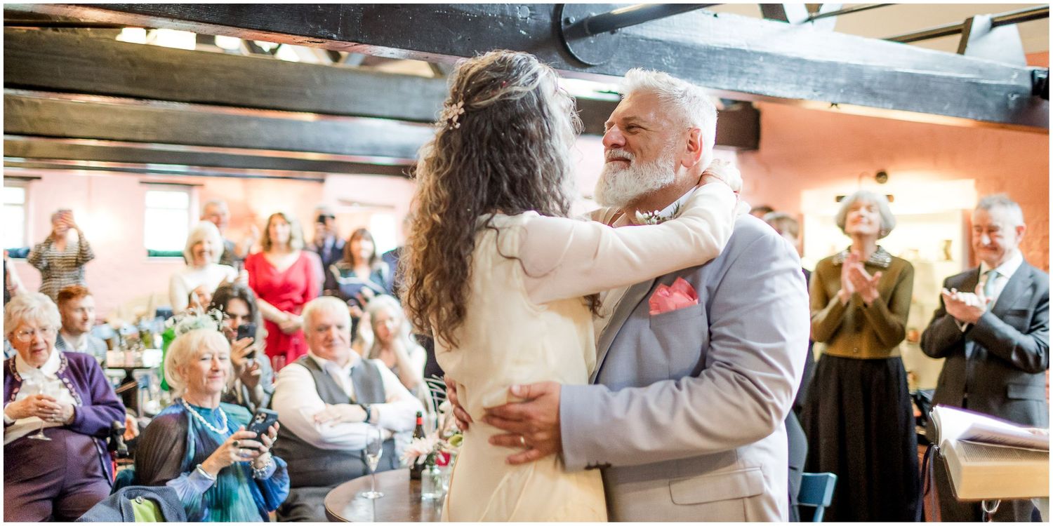 Winchester Abbey Mill wedding ceremony and reception photograph with bride and groom surrounded by guests celebrating their marriage.