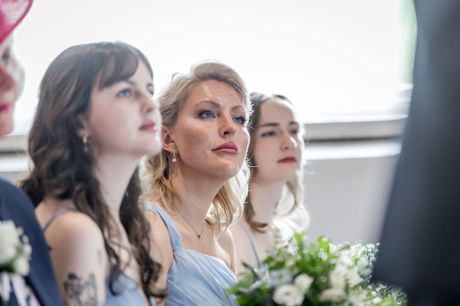 Wedding guests watching the ceremony in an elegant indoor setting.