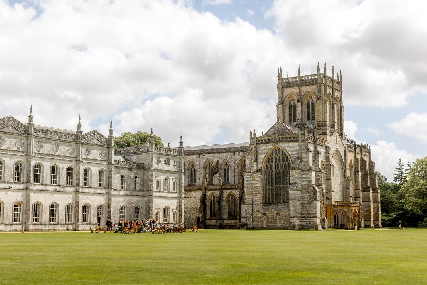 Gothic cathedral exterior with ornate spires and architecture under cloudy sky.