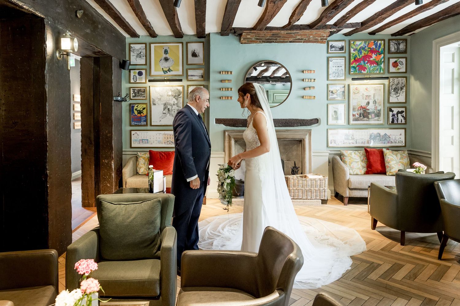 Sunlit vintage room with exposed beams showcases intimate wedding moment.