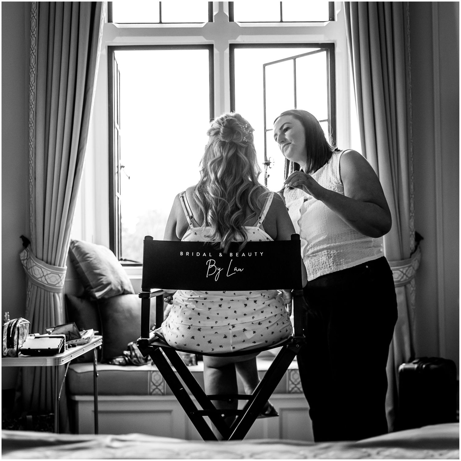 Black and white photo series showing two people sitting by a window in a room with curtains and natural lighting.