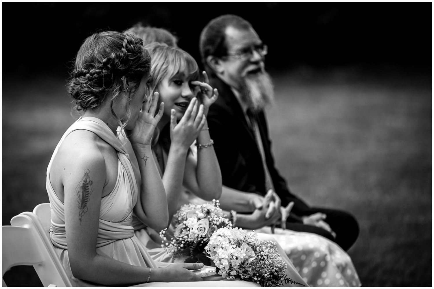 Black and white candid wedding photos showing intimate moments between couples and guests during an outdoor celebration.