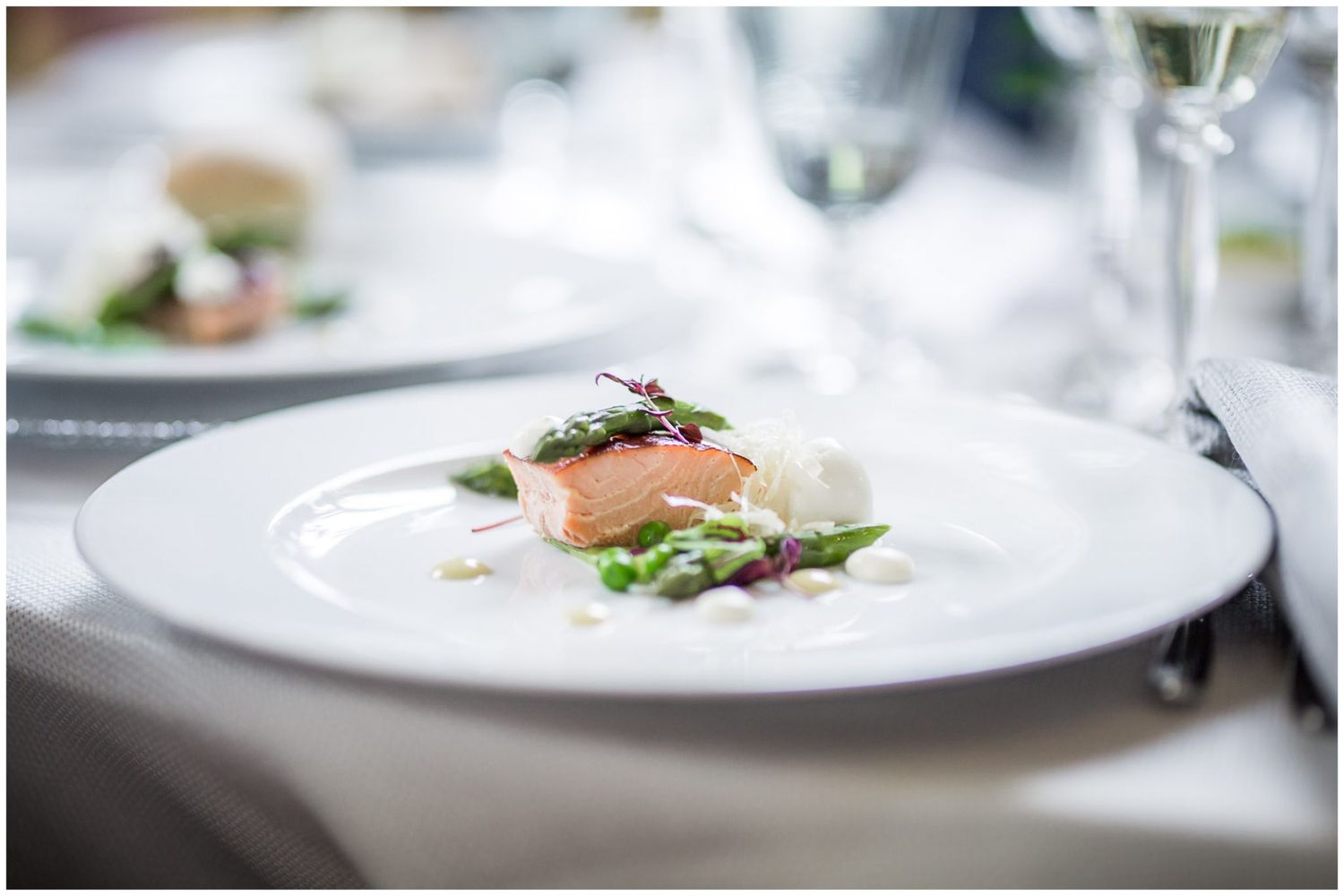 Elegant plated wedding dinner dishes with gourmet presentation.