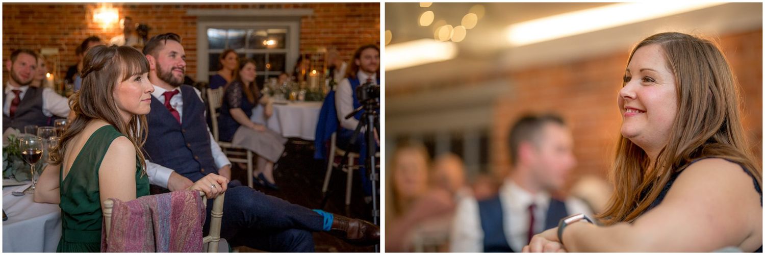 Wedding guests dancing and celebrating at an indoor reception with brick walls.
