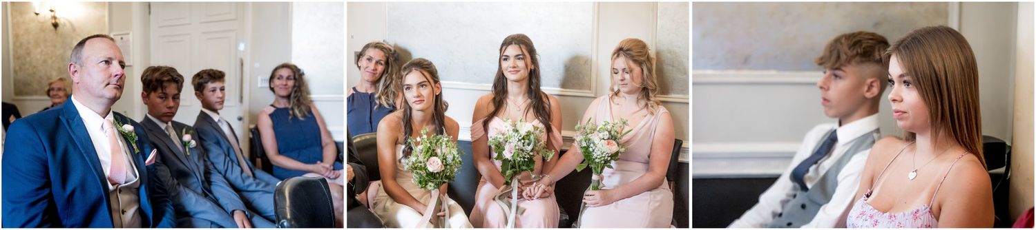 Wedding guests and party members gather for celebration photos in an elegant venue.