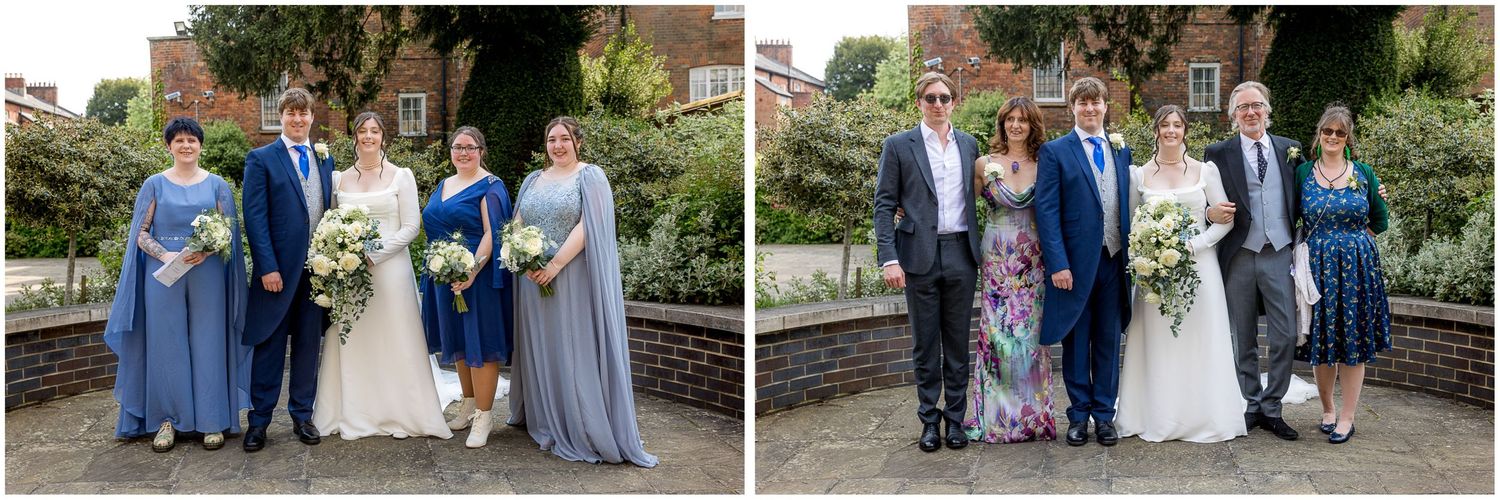 Large group wedding photo taken outside historic brick church with trees in background.