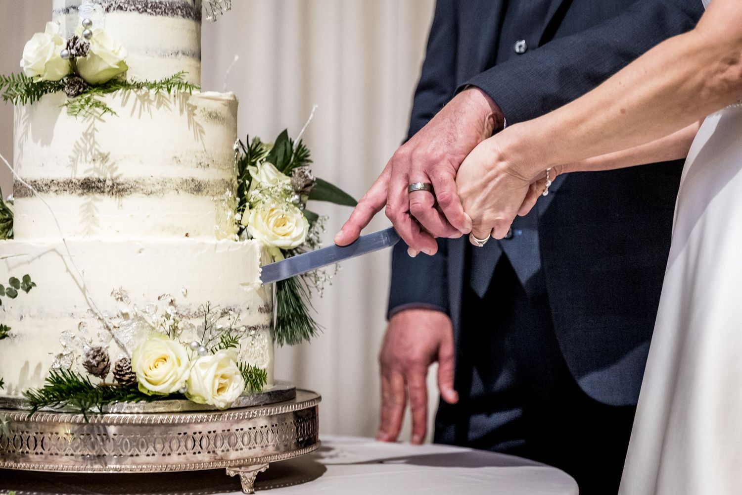 Cutting the cake in the main ceremony room at Clock Barn wedding venue near Whitchurch