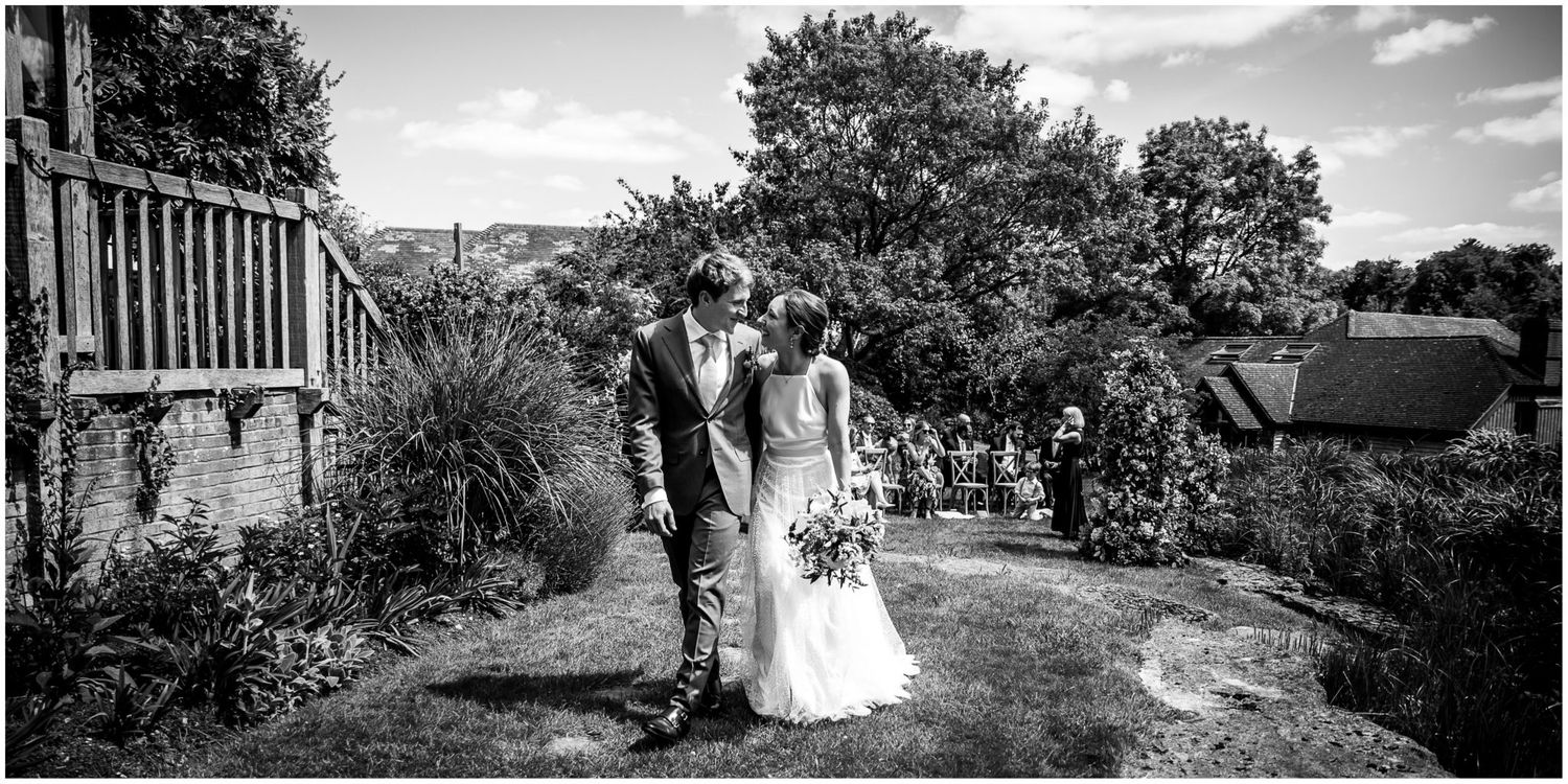 Black and white panoramic views of outdoor wedding ceremony with garden landscapes.