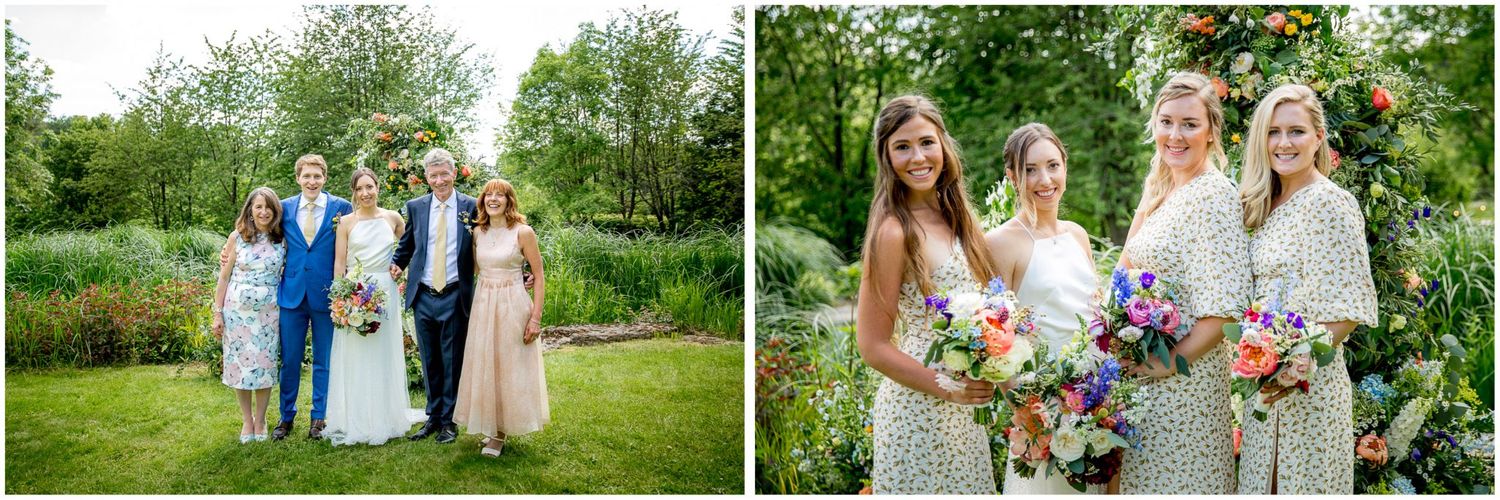 Wedding party gathered in a lush green garden setting with floral arrangements and summer attire.