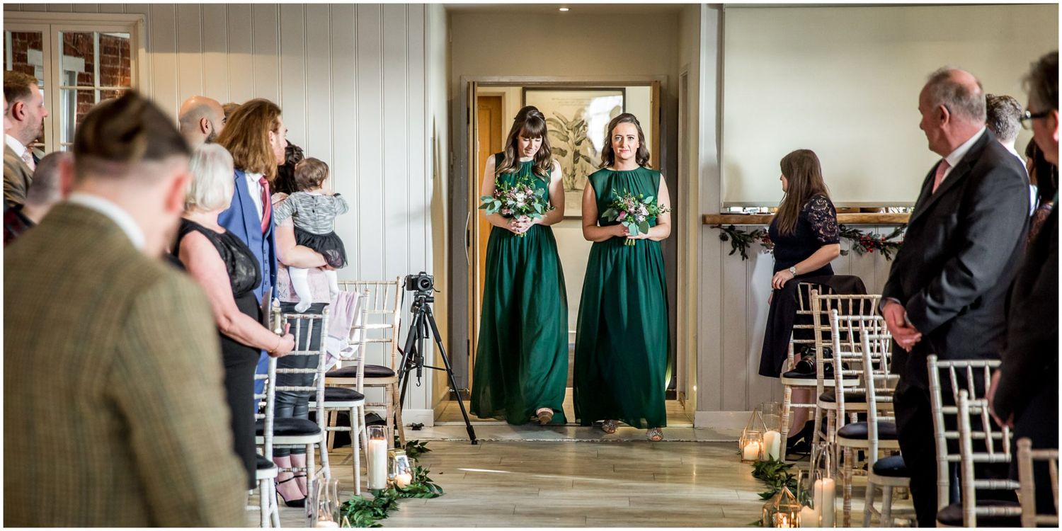 Indoor wedding venue with exposed brick walls and white chairs set up for ceremony.