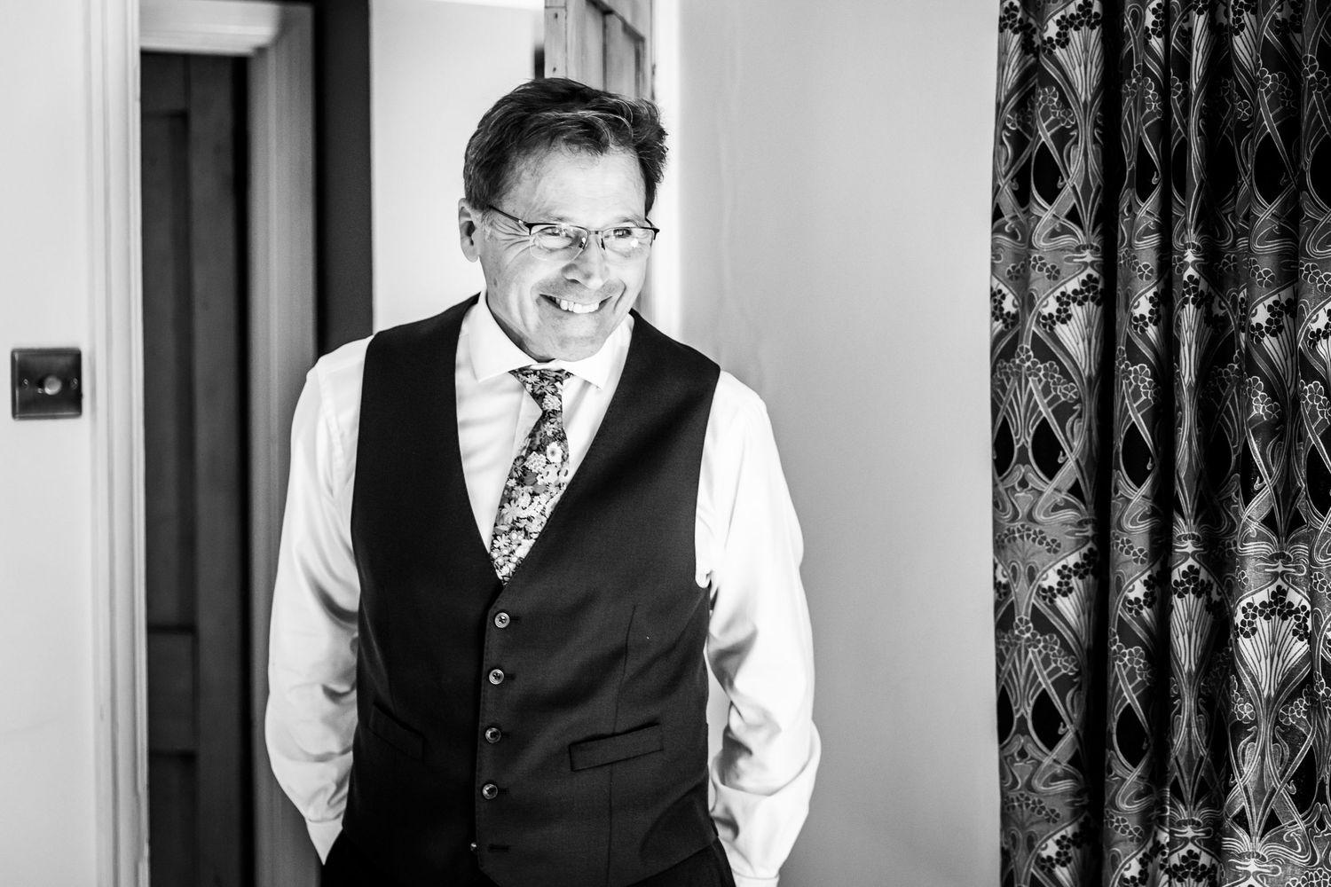 Black and white photos of formal wedding attire preparations indoors.