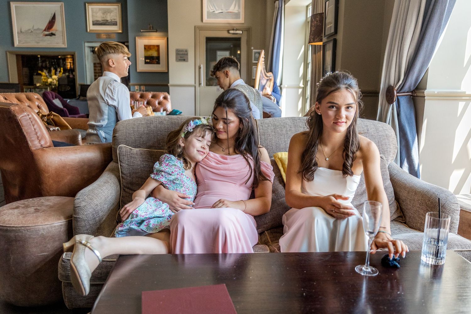 Casual gathering in a home living room with comfortable brown leather seating.