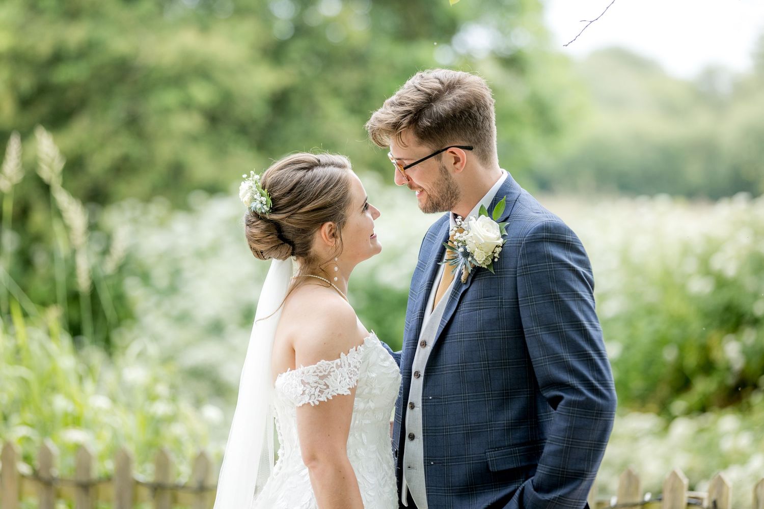 Intimate wedding moments captured in natural garden setting with soft lighting.