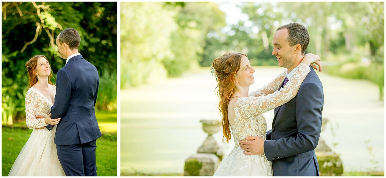 A couple shares an intimate moment in a sunlit garden setting during their wedding celebration.
