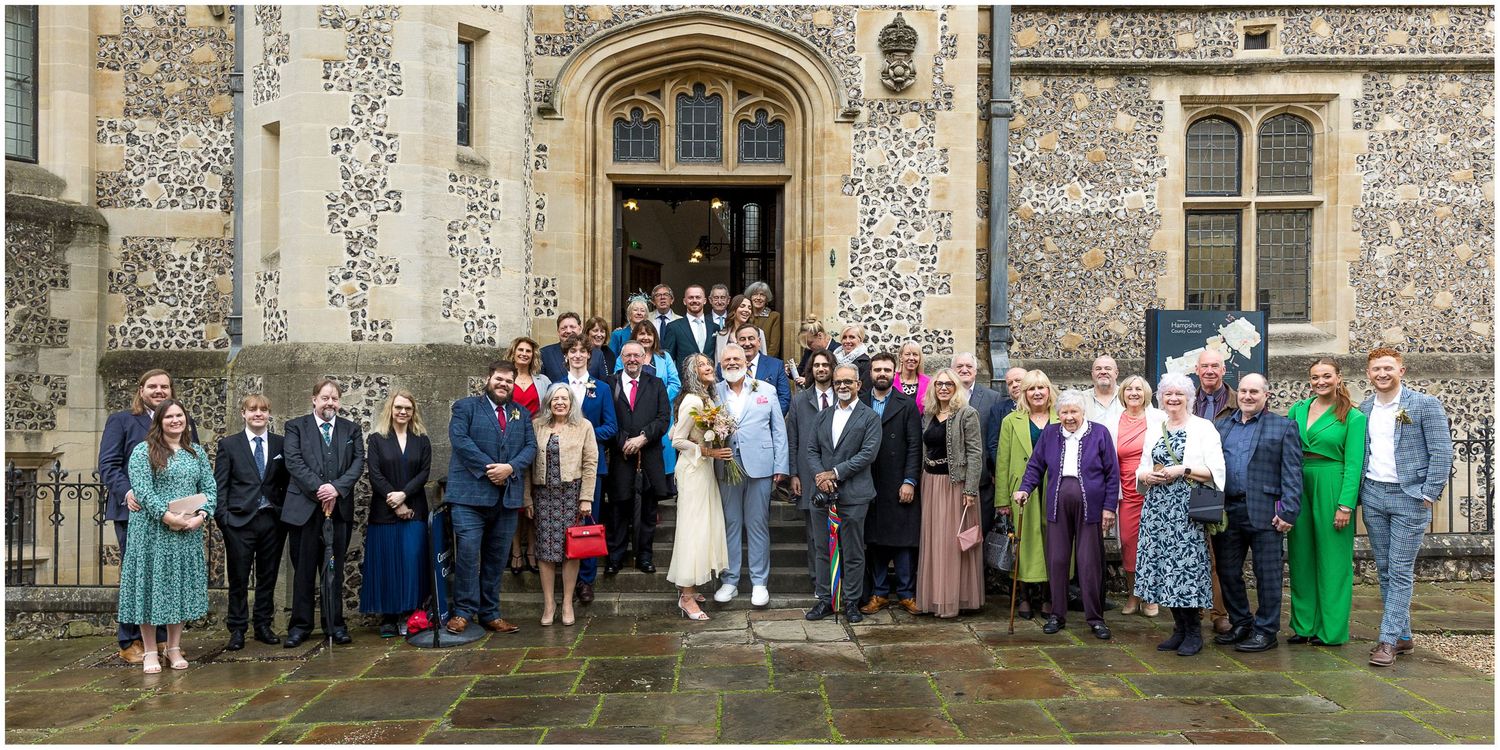 Large group of wedding guests on the steps outside Winchester registry office.