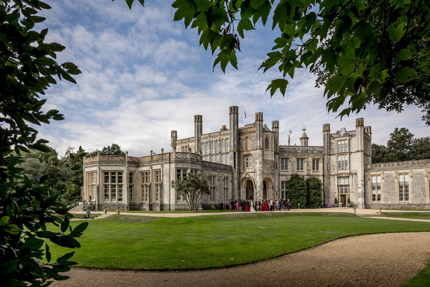 Panoramic view of historic mansion with manicured lawns and classical architecture.