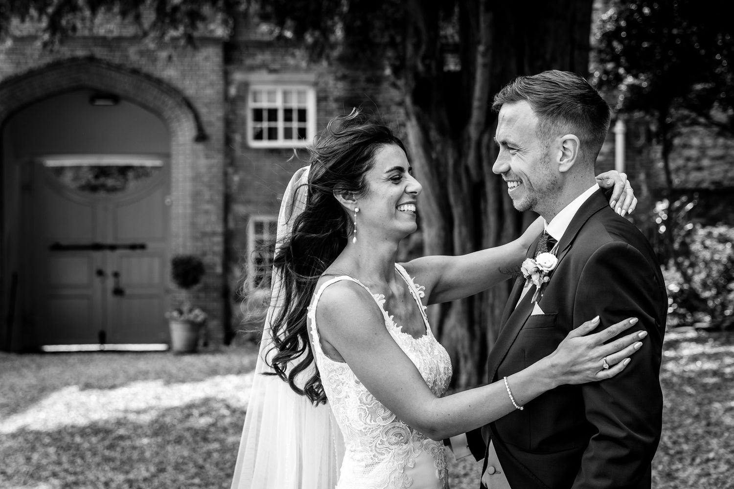 Candid black and white wedding photos showing emotional moments between couple.