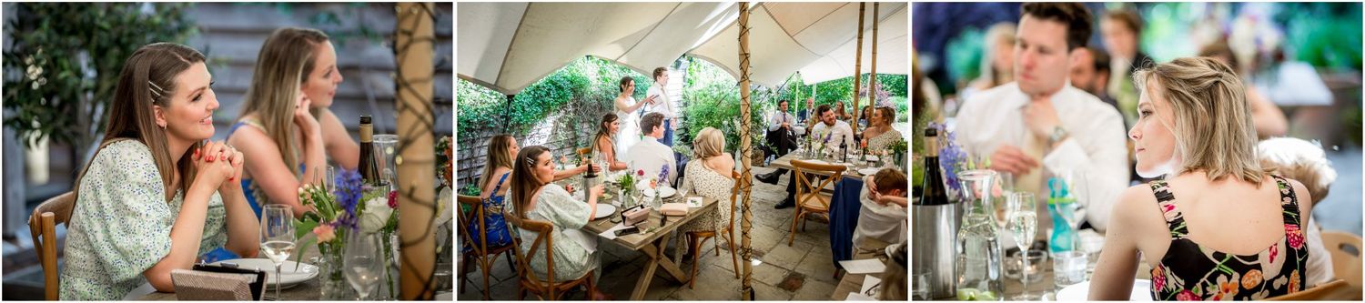 Outdoor wedding reception featuring tropical decor and guests gathered around dining tables.