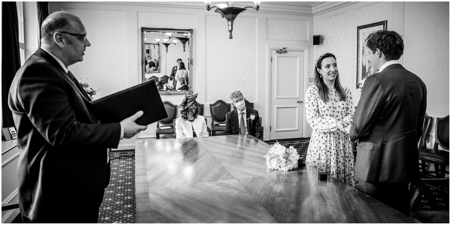 Black and white photos showing intimate moments during an indoor ceremony.