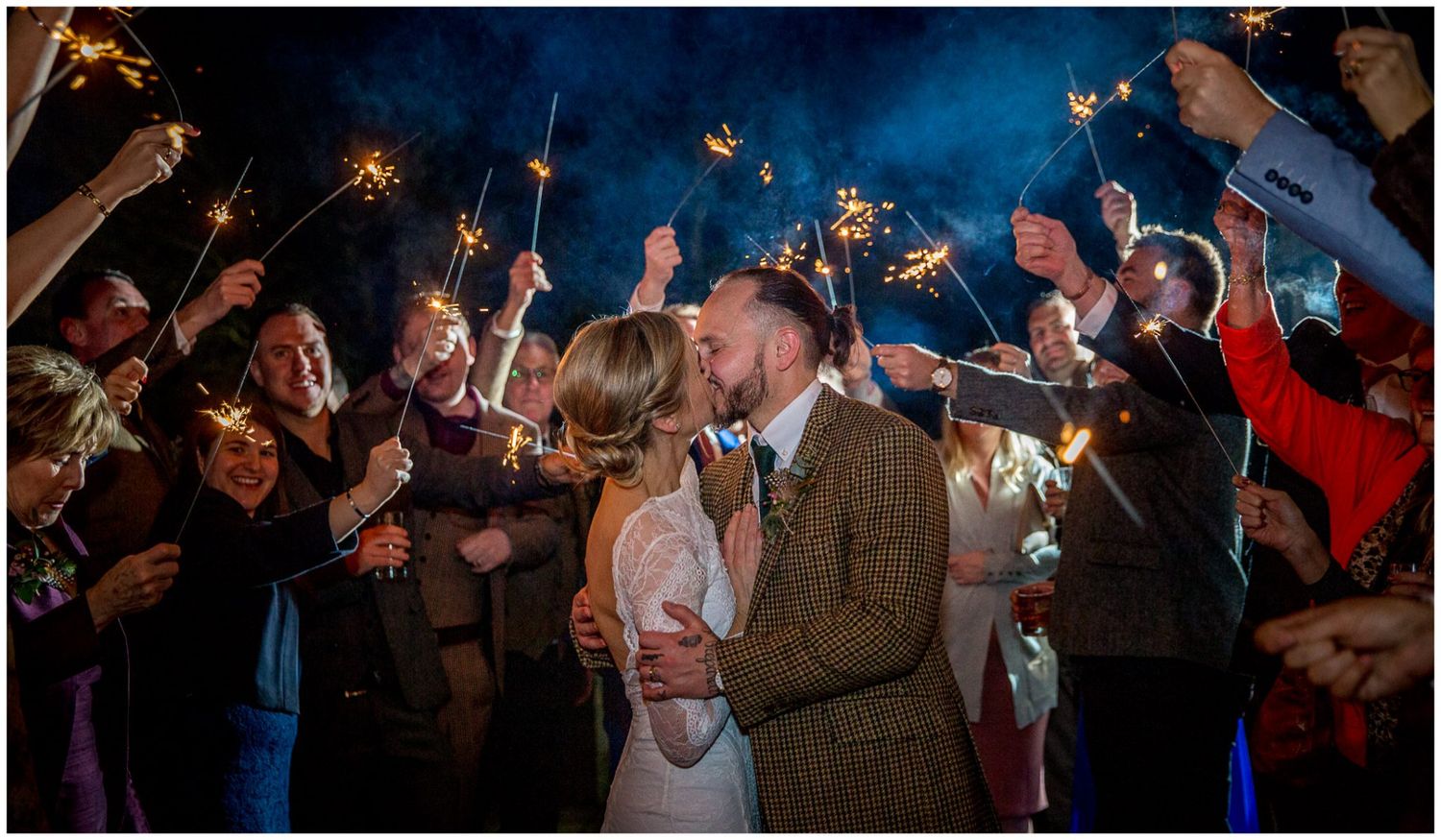 A sparkler exit on the bridge outside Sopley Mill, Christchurch wedding venue, at dusk