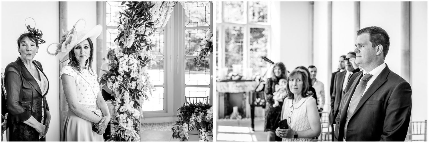 Elegant wedding ceremony in bright indoor venue with white columns and natural light.