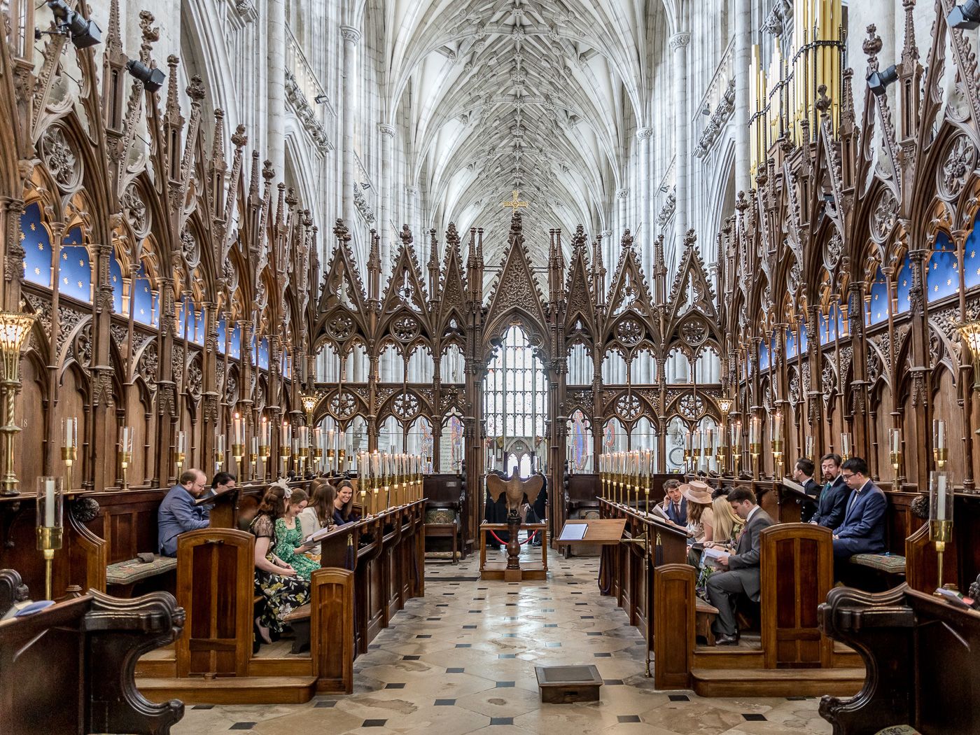 Gothic cathedral interior with ornate vaulted ceilings and wooden choir stalls.