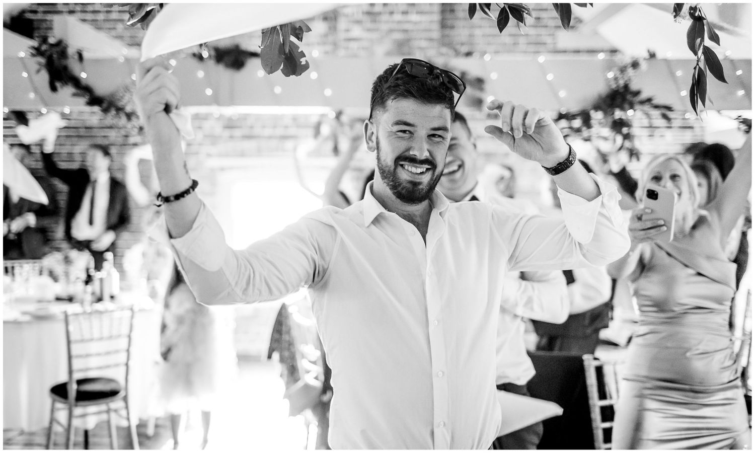 Joyful celebration scenes from a wedding reception with guests enjoying the festivities.