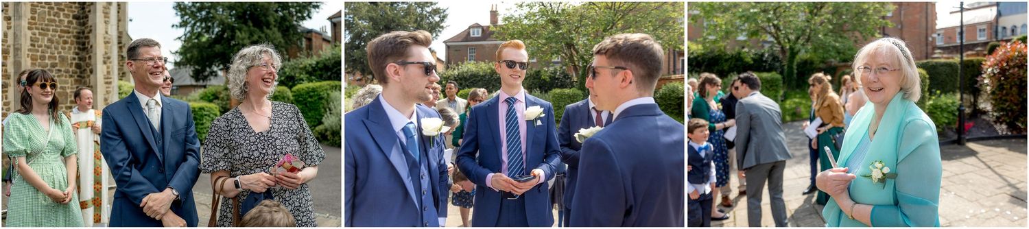 Wedding guests mingling outside church on sunny summer afternoon.