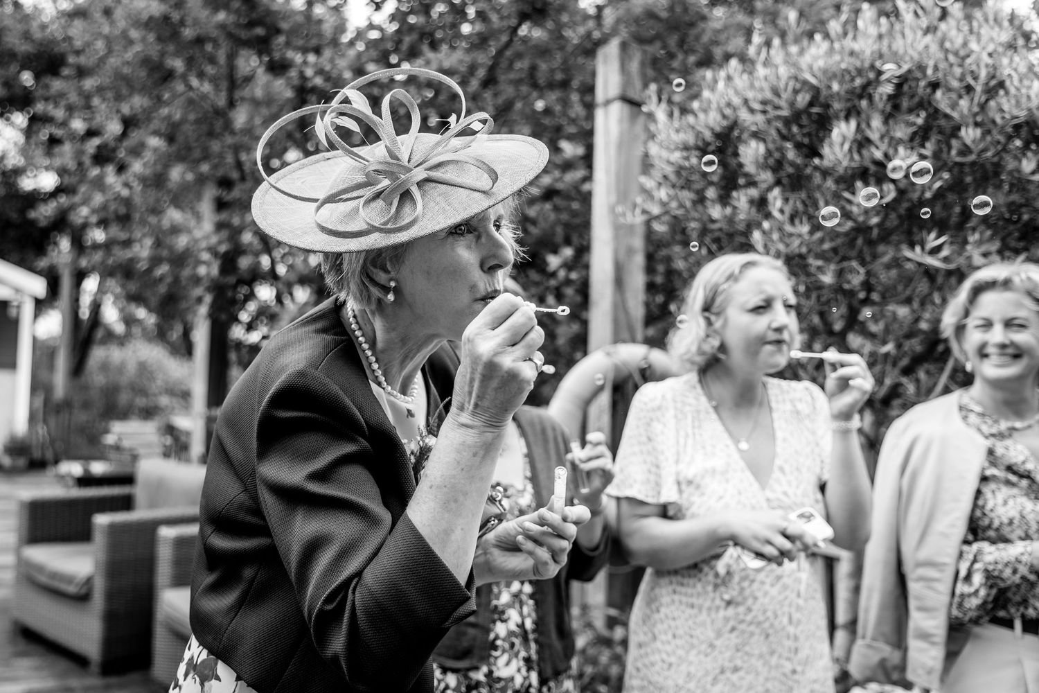 Black and white photo of wedding guests sharing emotional moments during the celebration.