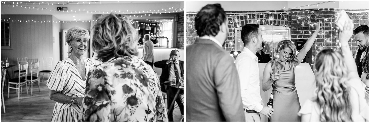 Black and white wedding reception photo showing guests mingling and conversing at Sopley Mill