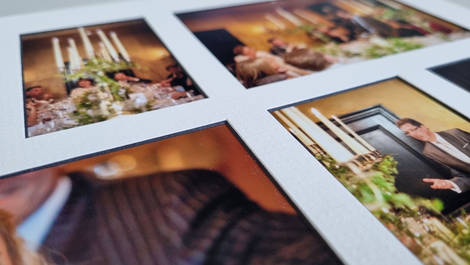 Several wedding photographs arranged on a white surface showing floral details and romantic moments.