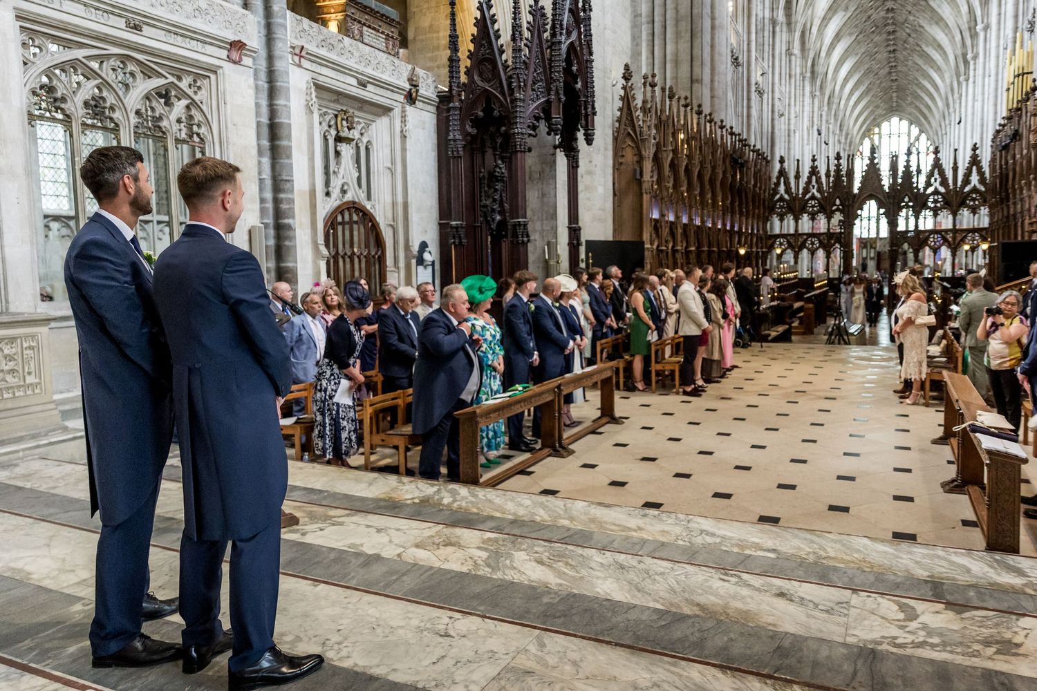 Gothic cathedral interior showcases stunning architectural details and checkered floor pattern.