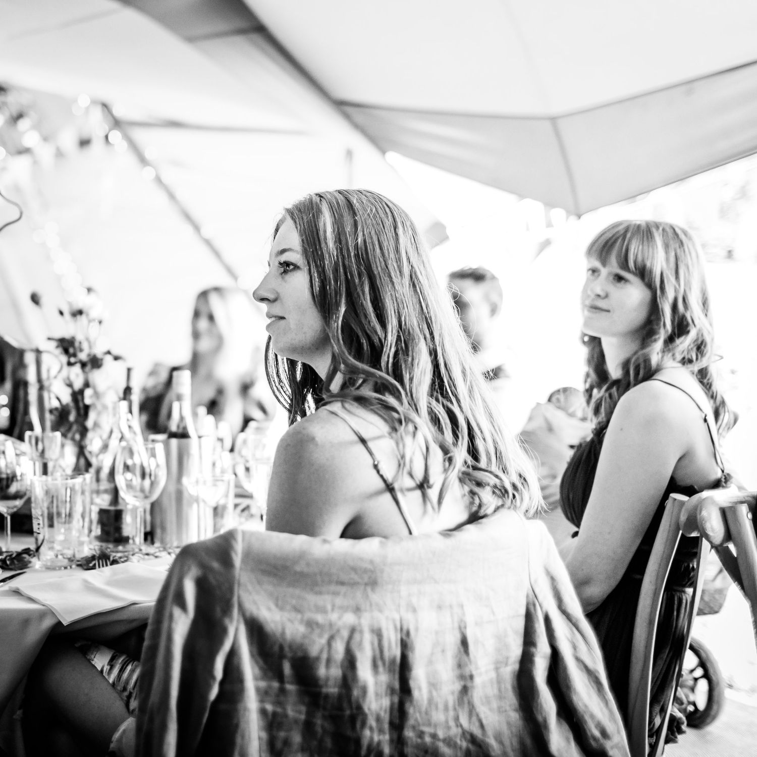 Black and white candid shots of guests enjoying themselves at a wedding reception.