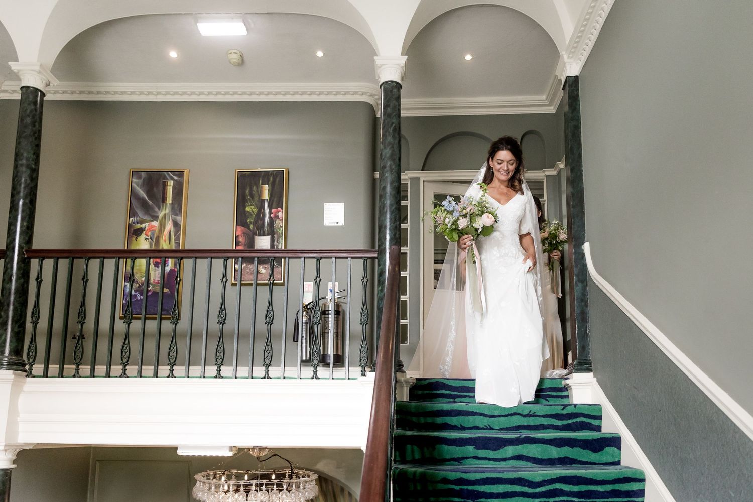 Modern staircase and interior of an elegant white-walled venue space.