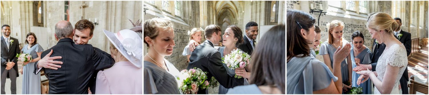 Wedding party and guests mingling in the church aisle after the ceremony.