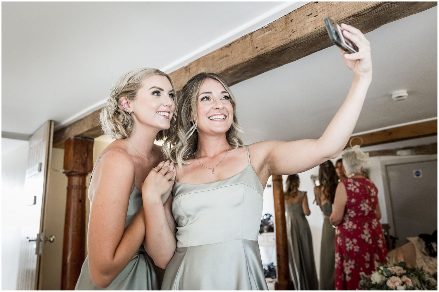 Bridesmaids pose for a selfie in the Avon Suite, the bridal prep and dressing room at Sopley Mill, Dorset wedding venue